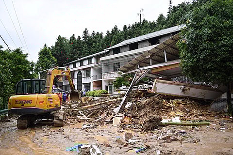 Excavator works near a collapsed building in Hengyang city